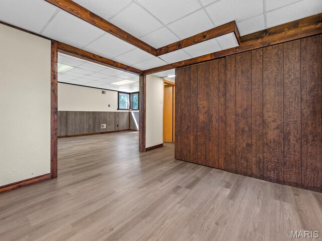 4488 Rock Creek Valley Rd, House Springs, MO 63051 - spare room with light wood-style flooring, wooden walls, and wainscoting