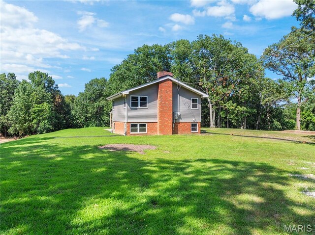 4488 Rock Creek Valley Rd, House Springs, MO 63051 - view of side of home with a chimney, a yard, and brick siding