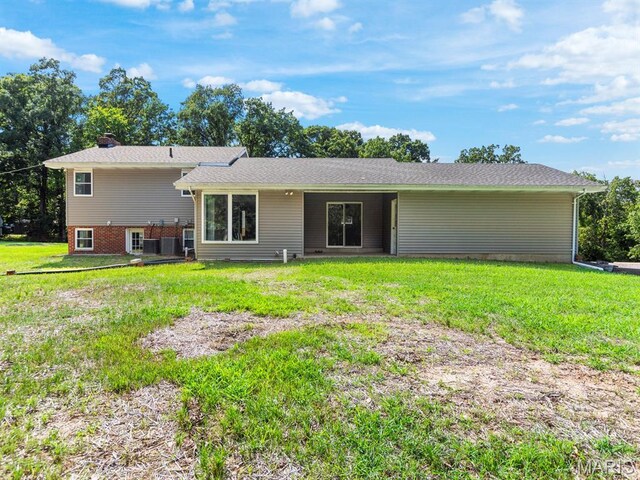 4488 Rock Creek Valley Rd, House Springs, MO 63051 - back of house featuring a chimney and a lawn