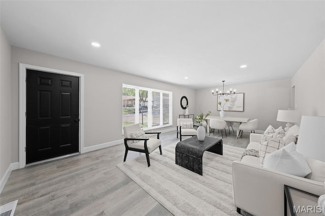 6781 Lesli Mari Ct, Florissant, MO 63033 - living area featuring light wood-type flooring, a chandelier, and recessed lighting