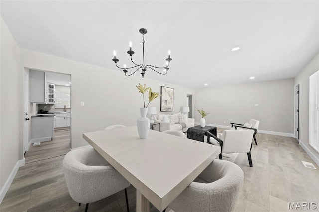 6781 Lesli Mari Ct, Florissant, MO 63033 - dining area featuring a chandelier, light wood-style flooring, and recessed lighting