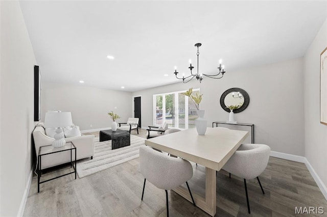 6781 Lesli Mari Ct, Florissant, MO 63033 - dining area with a chandelier, wood finished floors, and recessed lighting