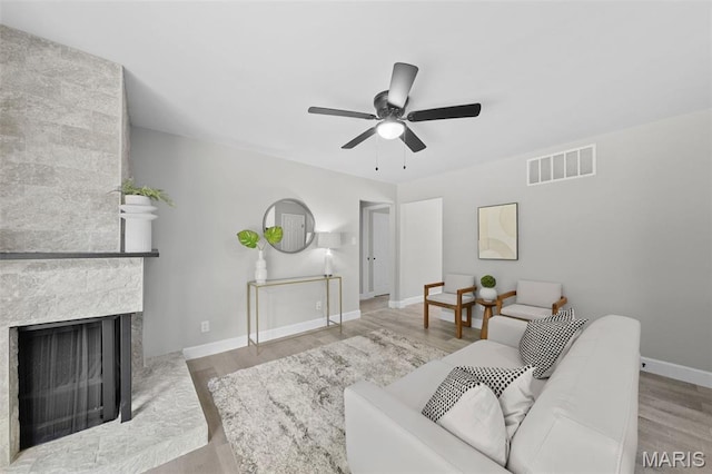 6781 Lesli Mari Ct, Florissant, MO 63033 - living room with a ceiling fan, wood finished floors, and a multi sided fireplace