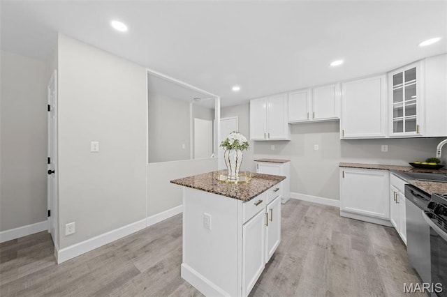 6781 Lesli Mari Ct, Florissant, MO 63033 - kitchen featuring light wood-style floors, white cabinetry, glass insert cabinets, and recessed lighting