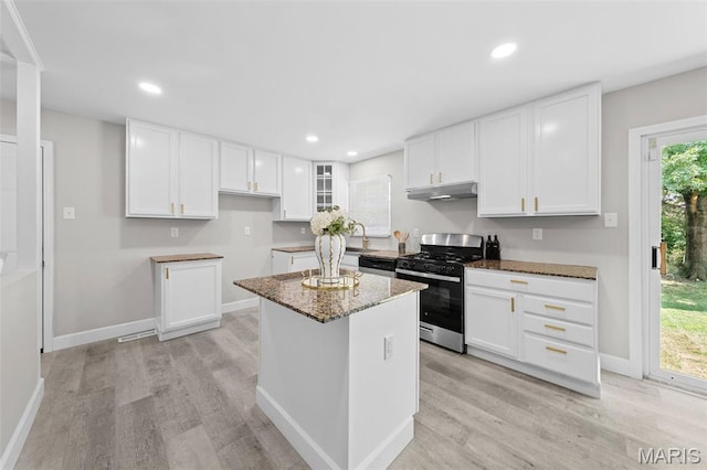 6781 Lesli Mari Ct, Florissant, MO 63033 - kitchen with appliances with stainless steel finishes, under cabinet range hood, light wood-style floors, white cabinetry, and recessed lighting