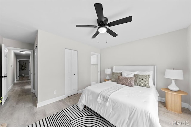 6781 Lesli Mari Ct, Florissant, MO 63033 - bedroom featuring light wood-type flooring, ceiling fan, and a closet