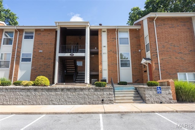 1989 Hunting Lake Ct Unit 201, Kirkwood, MO 63122 - view of property featuring uncovered parking and stairway