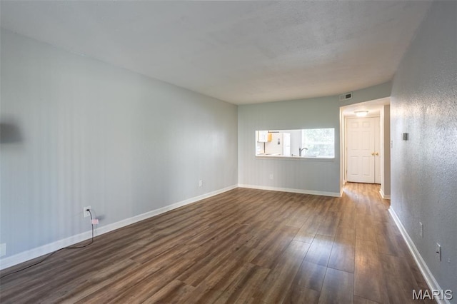 1989 Hunting Lake Ct Unit 201, Kirkwood, MO 63122 - unfurnished room with dark wood-type flooring and a textured wall