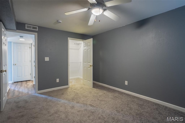 1989 Hunting Lake Ct Unit 201, Kirkwood, MO 63122 - unfurnished bedroom with carpet floors, a ceiling fan, and a spacious closet