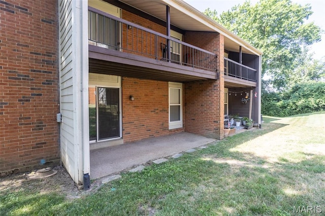 1989 Hunting Lake Ct Unit 201, Kirkwood, MO 63122 - rear view of property with a balcony, a yard, a patio, and brick siding