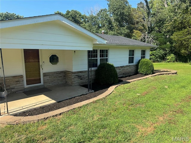 8705 State Road Y, Dittmer, MO 63023 - view of front facade with stone siding, a front lawn, a patio, and a shingled roof