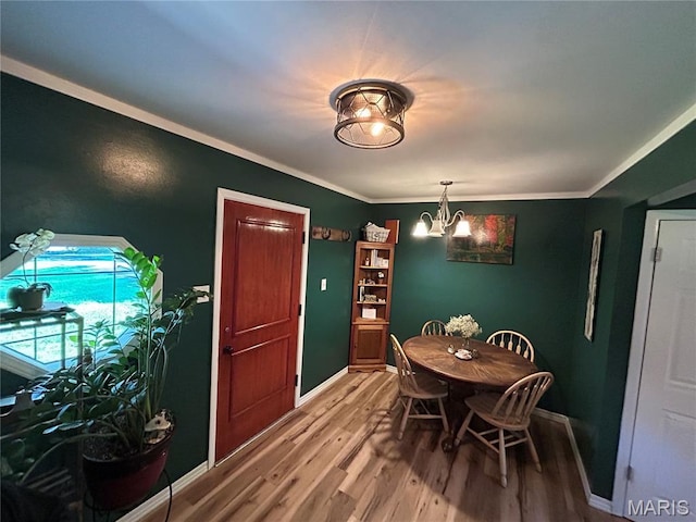 8705 State Road Y, Dittmer, MO 63023 - dining room with wood finished floors, a chandelier, and ornamental molding