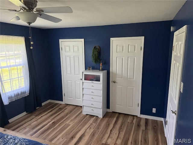 8705 State Road Y, Dittmer, MO 63023 - unfurnished bedroom with wood finished floors and ceiling fan