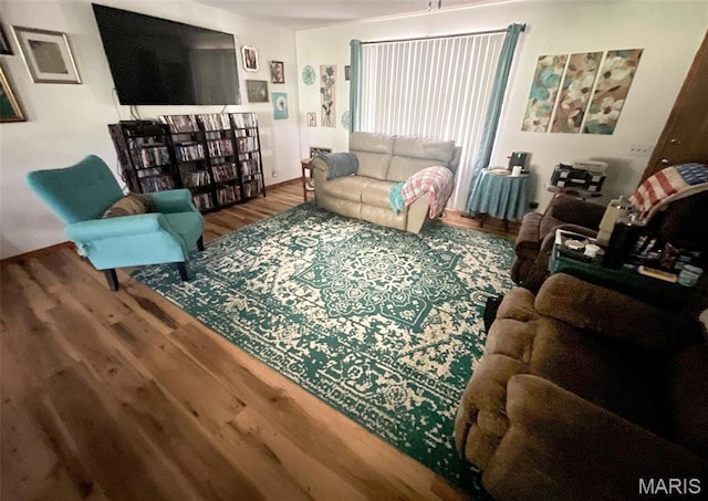 402 N Viola St, Bloomfield, MO 63825 - living area featuring wood finished floors and radiator