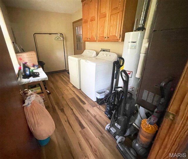 402 N Viola St, Bloomfield, MO 63825 - laundry room featuring washer and dryer, cabinet space, gas water heater, and wood finished floors