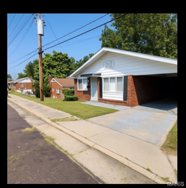 2623 Hord Ave, Jennings, MO 63136 - ranch-style house with brick siding, a front yard, and concrete driveway