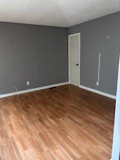 2623 Hord Ave, Jennings, MO 63136 - spare room featuring wood finished floors and a textured ceiling