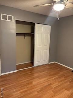 2623 Hord Ave, Jennings, MO 63136 - unfurnished bedroom featuring a closet, wood finished floors, and ceiling fan