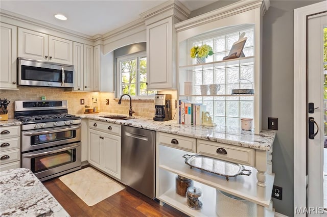 1225 Wissmann Dr, Ballwin, MO 63011 - kitchen with appliances with stainless steel finishes, dark wood-type flooring, backsplash, light stone countertops, and recessed lighting