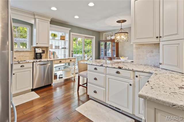 1225 Wissmann Dr, Ballwin, MO 63011 - kitchen featuring stainless steel appliances, a peninsula, plenty of natural light, backsplash, and recessed lighting