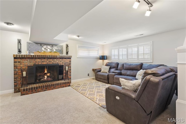 1225 Wissmann Dr, Ballwin, MO 63011 - living room with a fireplace, carpet flooring, and rail lighting