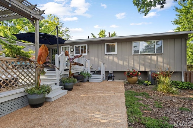 1225 Wissmann Dr, Ballwin, MO 63011 - view of front facade with board and batten siding, a wooden deck, and a pergola