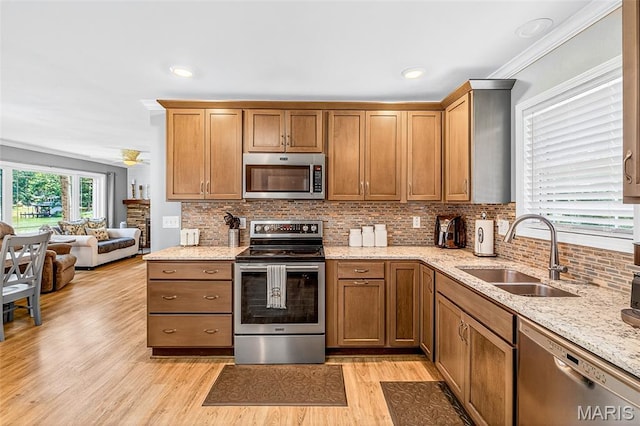 11178 Catatoga Dr, Plainview, IL 62685 - kitchen with appliances with stainless steel finishes, light wood-style floors, decorative backsplash, light stone counters, and open floor plan
