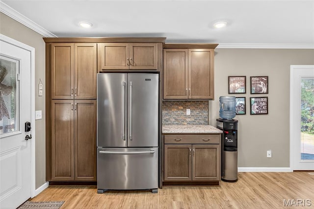 11178 Catatoga Dr, Plainview, IL 62685 - kitchen featuring high end refrigerator, backsplash, crown molding, light wood-style floors, and light stone countertops