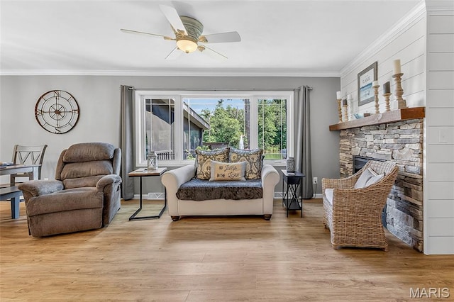 11178 Catatoga Dr, Plainview, IL 62685 - living area featuring ornamental molding, wood finished floors, a ceiling fan, and a stone fireplace