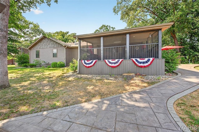 11178 Catatoga Dr, Plainview, IL 62685 - view of front of house featuring a sunroom and a front yard