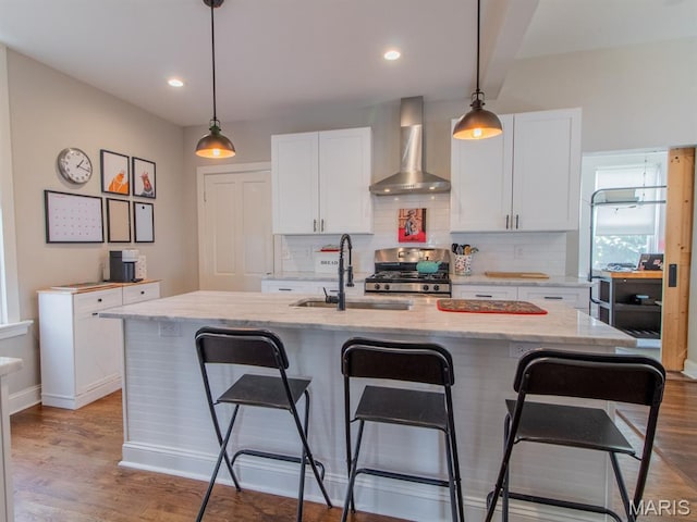 6454 Virginia Ave, Saint Louis, MO 63111 - kitchen featuring wall chimney range hood, stainless steel gas range, white cabinets, backsplash, and recessed lighting