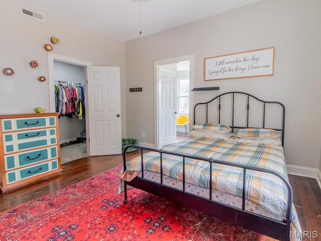 6454 Virginia Ave, Saint Louis, MO 63111 - bedroom with wood finished floors and a walk in closet