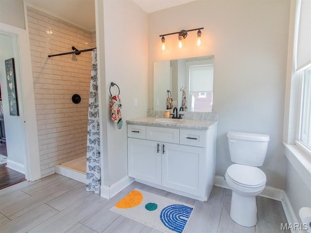 6454 Virginia Ave, Saint Louis, MO 63111 - full bathroom with vanity, tiled shower, and wood finished floors