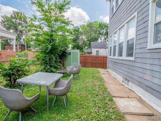 6454 Virginia Ave, Saint Louis, MO 63111 - fenced backyard featuring a storage unit