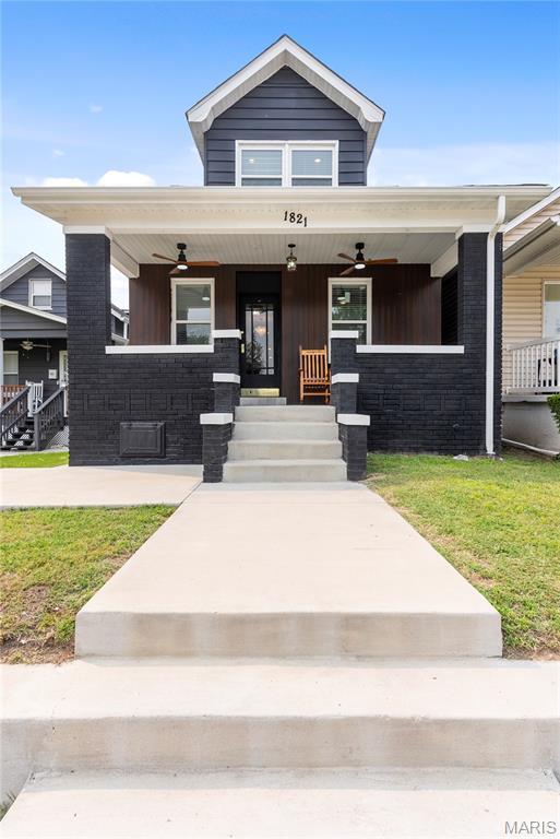 1821 Edwardsville Rd, Madison, IL 62060 - view of front of house featuring a porch, ceiling fan, and a front yard
