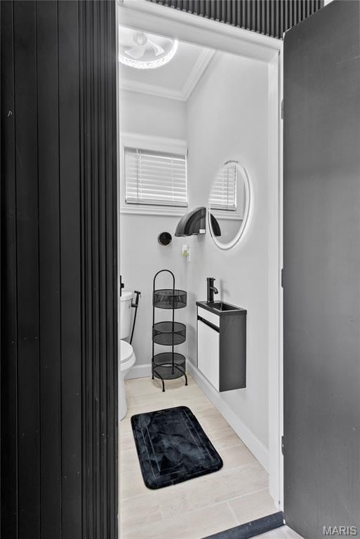 1821 Edwardsville Rd, Madison, IL 62060 - bathroom featuring toilet and ornamental molding