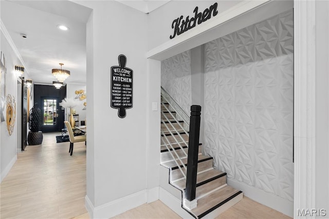 1821 Edwardsville Rd, Madison, IL 62060 - stairs featuring ornamental molding, wood finished floors, a chandelier, and recessed lighting