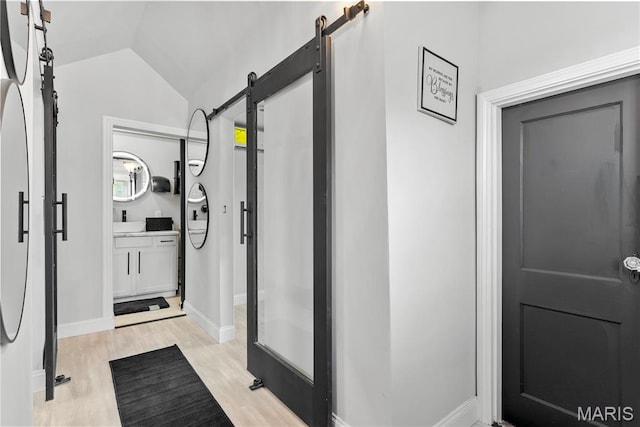1821 Edwardsville Rd, Madison, IL 62060 - bathroom featuring wood finished floors, vanity, and lofted ceiling