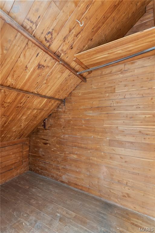 1821 Edwardsville Rd, Madison, IL 62060 - additional living space featuring lofted ceiling, wooden walls, wooden ceiling, and hardwood / wood-style flooring