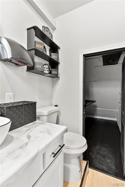 1821 Edwardsville Rd, Madison, IL 62060 - half bathroom featuring vanity and wood finished floors