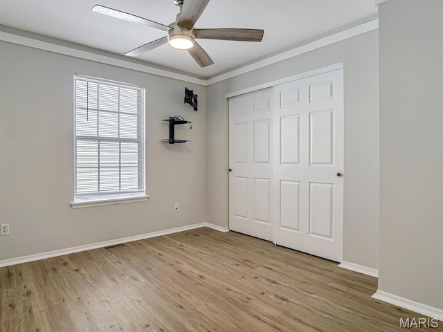 240 Brookmont Dr, Belleville, IL 62221 - unfurnished bedroom featuring light wood-type flooring, a closet, and a ceiling fan