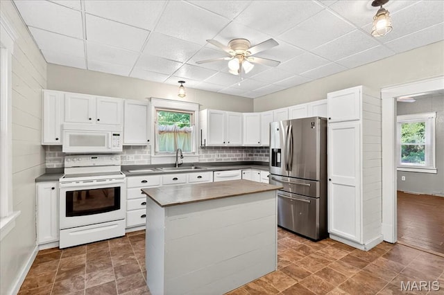 1404 State Route 156, Waterloo, IL 62298 - kitchen with white appliances, healthy amount of natural light, backsplash, white cabinets, and a paneled ceiling
