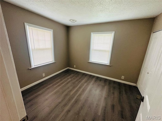 3418 Eastridge Ln, Saint Louis, MO 63074 - unfurnished bedroom featuring a textured ceiling, dark wood-type flooring, and a closet