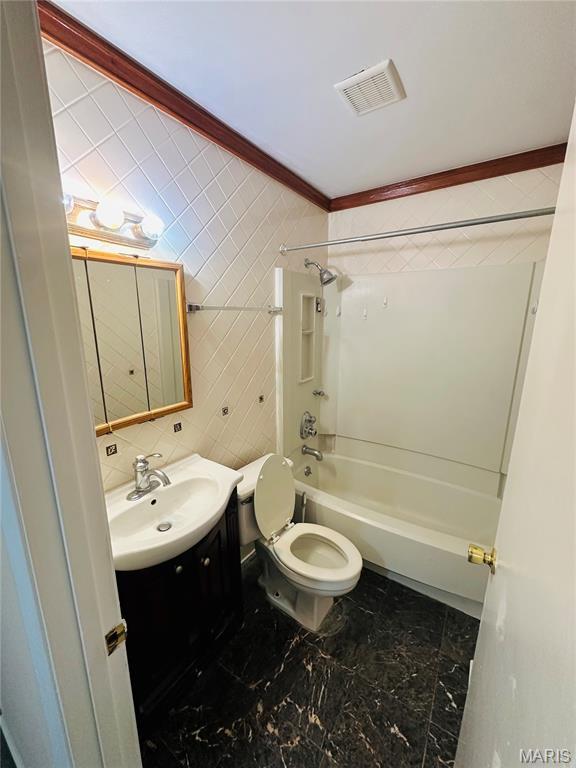 3418 Eastridge Ln, Saint Louis, MO 63074 - full bath featuring washtub / shower combination, vanity, tile walls, crown molding, and marble look tiles