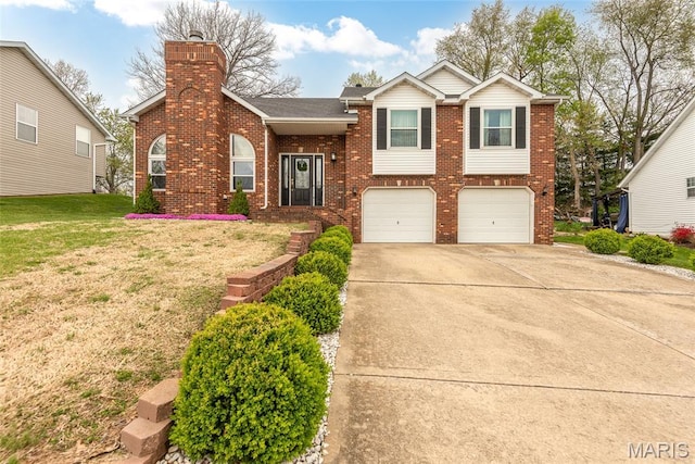 34 Windermere Dr, Glen Carbon, IL 62034 - view of front of home with brick siding, an attached garage, concrete driveway, a front lawn, and a chimney