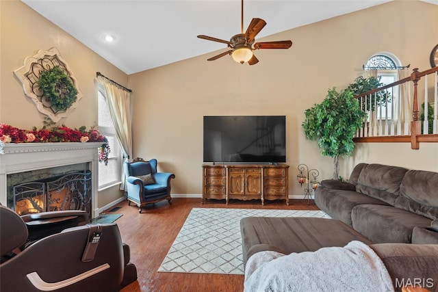 34 Windermere Dr, Glen Carbon, IL 62034 - living area featuring wood finished floors, a ceiling fan, vaulted ceiling, plenty of natural light, and a warm lit fireplace