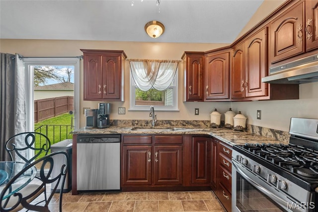 34 Windermere Dr, Glen Carbon, IL 62034 - kitchen featuring stainless steel appliances, under cabinet range hood, healthy amount of natural light, and dark stone counters