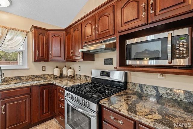 34 Windermere Dr, Glen Carbon, IL 62034 - kitchen with appliances with stainless steel finishes, under cabinet range hood, vaulted ceiling, and dark stone counters
