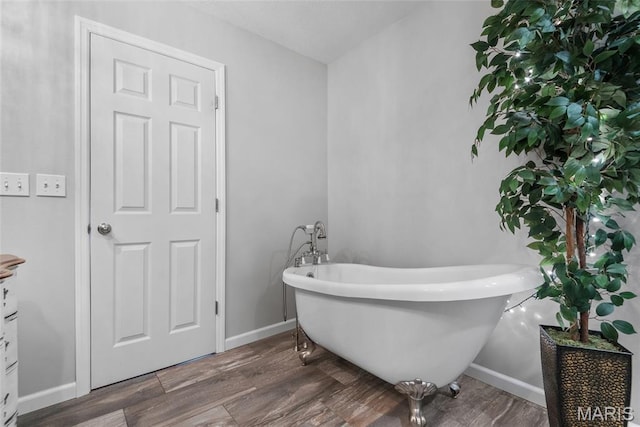 34 Windermere Dr, Glen Carbon, IL 62034 - bathroom with a freestanding bath and wood finished floors