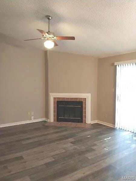 1446 Bluebird Ter, Saint Louis, MO 63144 - unfurnished living room with a textured ceiling, ceiling fan, a tiled fireplace, and wood finished floors
